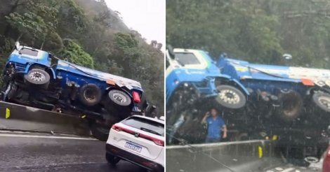 Caminhão fica atravessado em mureta de proteção, interdita faixas e trava o trânsito na BR-101, no Morro dos Cavalos